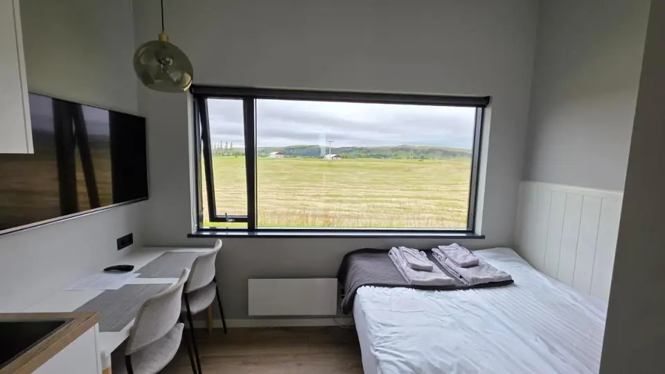 Small Double Room at Landbrot Guesthouse, with the bed facing the picture window