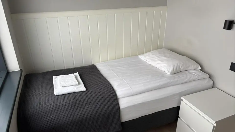Standard Single Room at Landbrot Guesthouse, with the bed facing the picture window